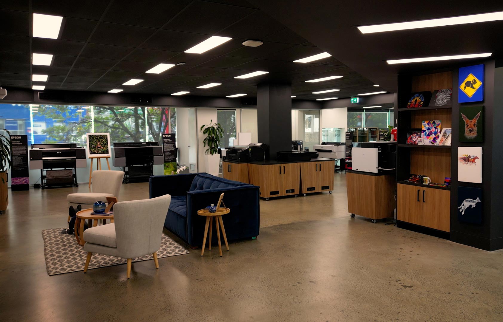 A picture of Melbourne experience centre showing kangaroos, koala and horse prints on the wall and some lounge furnitures