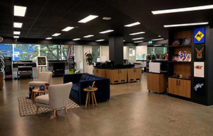 A picture of Melbourne experience centre showing kangaroos, koala and horse prints on the wall and some lounge furnitures